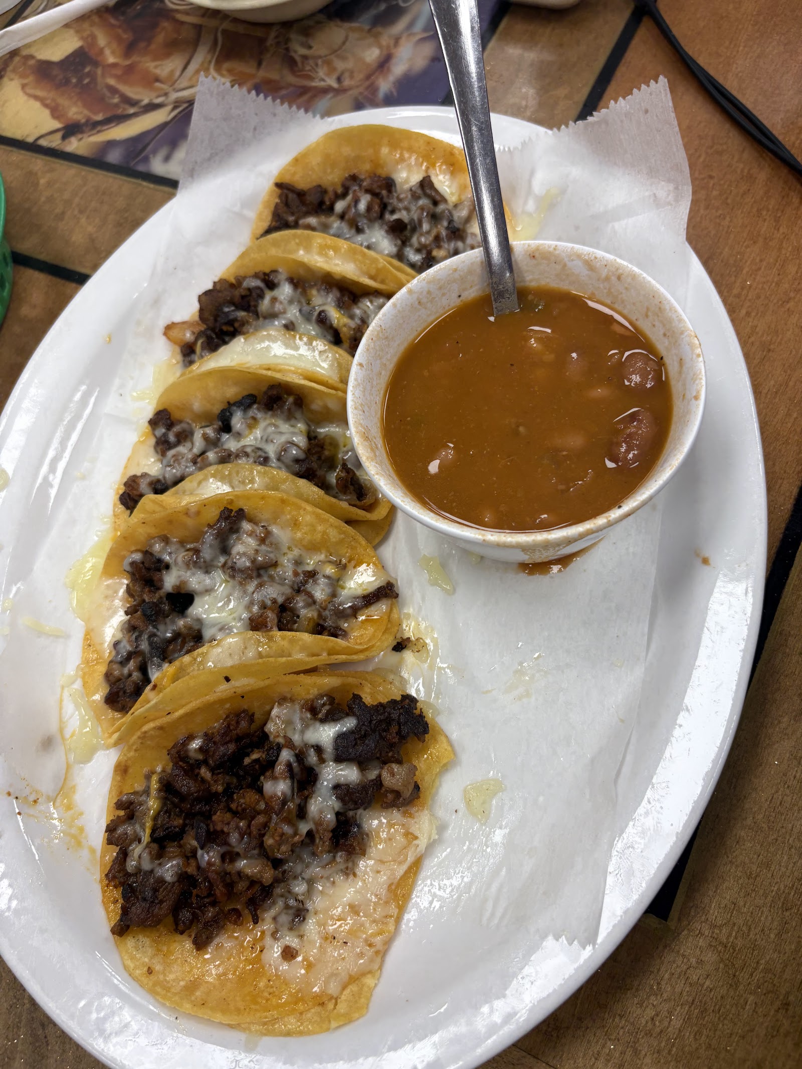 Cheese-and-meat tacos served with a bowl of borracho beans